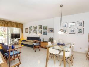 a living room with a table and chairs and a couch at Apartment Mar d'Aro by Interhome in Platja  d'Aro