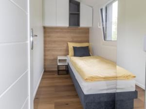 a small bedroom with a bed and a window at Holiday Home Karoline by Interhome in Aschach an der Steyr +7 photos