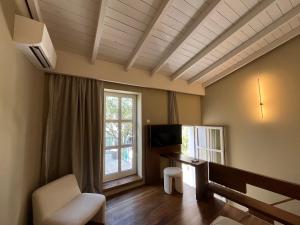 a living room with a desk and a window at Thirty8 Heritage House in Chania