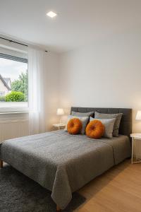a bedroom with a bed with two pumpkins on it at Köln Frechen 44 in Frechen