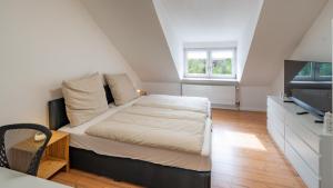 Katil atau katil-katil dalam bilik di Stilvolle Dachgeschosswohnung