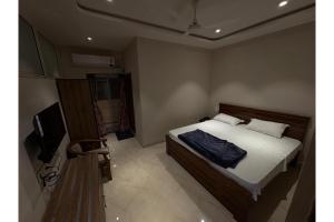 Ένα ή περισσότερα κρεβάτια σε δωμάτιο στο Vanathara INN