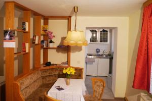 a kitchen with a table with a vase of flowers on it at Ferienwohnung Pferdestall in Reinhardtsdorf