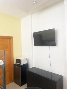 Una sala de estar con un televisor en la pared. en City Caribbean Hotel Boutique, en Santo Domingo 33 fotos más