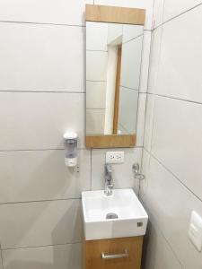 a bathroom with a sink and a mirror at City Caribbean Hotel Boutique in Santo Domingo