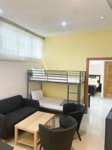 a living room with a couch and a bunk bed at City Caribbean Hotel Boutique in Santo Domingo +31 photos