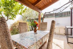 a table and chairs on a patio with a table at Trullimania in Alberobello