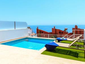 a swimming pool with the ocean in the background at Apartment Bayviewhills Amazing Spa & Padel by Interhome in Torrox Costa