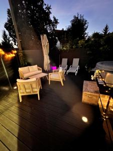 a group of chairs and tables on a deck at night at Agréable maison de ville dans quartier calme in Bourges
