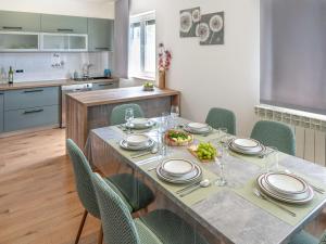 a kitchen with a table and chairs with a meal on it at Holiday Home Gabi by Interhome in Brtonigla