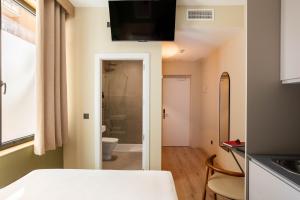 a room with a bathroom with a toilet and a sink at Ola Living Chamartín Studios in Madrid +22 photos