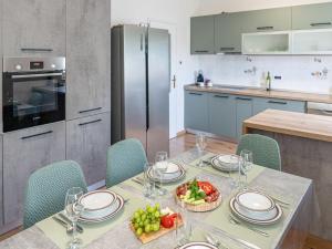 a kitchen with a table with a bowl of fruit on it at Holiday Home Gabi by Interhome in Brtonigla
