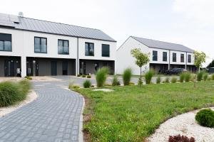 a house with a walkway in front of a building at Apartament 3 z ogródkiem in Sieniawa Żarska