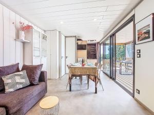 a living room with a couch and a table at Holiday Home Chalet moderne La Baule-Guérande by Interhome in Guérande
