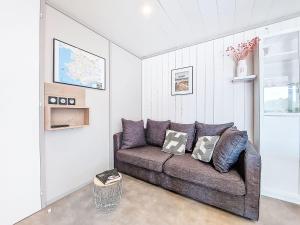 a living room with a couch in a room at Holiday Home Chalet moderne La Baule-Guérande by Interhome in Guérande +24 photos