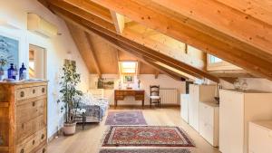 a kitchen and living room with wooden ceilings at Rebecca House, Sestri Levante in San Bernardo