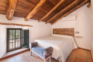 a bedroom with a bed and a chair at Finca Las Cabrillas La Nava in La Nava +20 photos