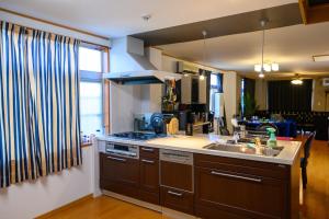 a kitchen with a sink and a stove at space AJITO in Kofu