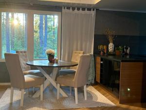 a dining room with a table and chairs and a window at Charmig stuga nära Dammsjön in Gustafs