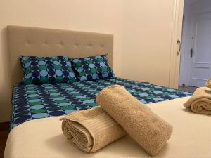 a bed with a towel on top of it at AMPLIO PISO EN CENTRO DE TORRE DEL MAR in Torre del Mar