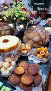 a table with many different types of bread and pastries at Pousada Ágape in Chapada dos Guimarães +16 photos