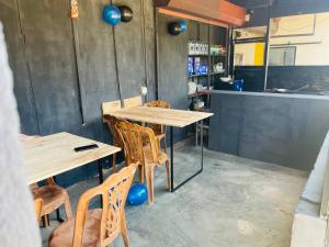 a dining room with two tables and chairs and blue balloons at Rahangala edge in Boralanda