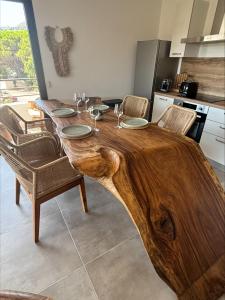 a wooden table with chairs and a table with a wooden tree stumpimateimateccess at A Isula Paradisu - Classé 4 étoiles in LʼÎle-Rousse