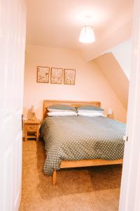 a bedroom with a bed in a attic at Romantic Country Cottage with Private Hot Tub in Rowde