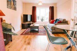 a living room with a couch and a table at Romantic Country Cottage with Private Hot Tub in Rowde
