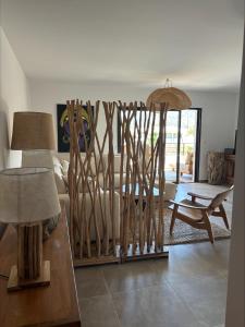 a living room with a bunch of wooden sticks at A Isula Paradisu - Classé 4 étoiles in LʼÎle-Rousse