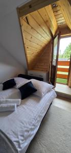 Una cama grande en una habitación con techo de madera. en Apartament u Krupy, en Murzasichle 22 fotos más