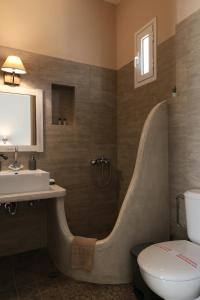 a bathroom with a sink and a bath tub at Niriides rooms in Kionia
