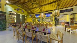 a dining room with a long table and chairs at Adhi Jaya Hotel in Kuta