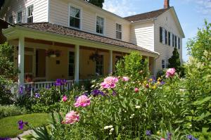 a house with flowers in the front yard at Royal Manor Bed & Breakfast in Niagara-on-the-Lake