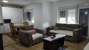 a living room with a couch and a table at Smeštaj Golubica in Soko Banja