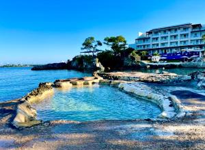 a swimming pool in the water next to a building at Gorgeous 1 Bedroom Gem at 7 Miles Beach Negril Point Village in Negril Aerodrome