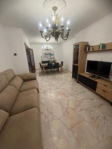 a living room with a couch and a chandelier at Casa Parlera in Ribeira
