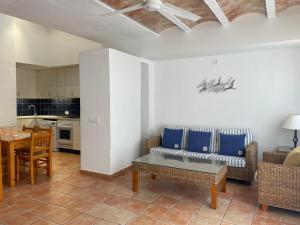 a living room with a couch and a table at Sa TORRE 3 by SOM Menorca in Fornells