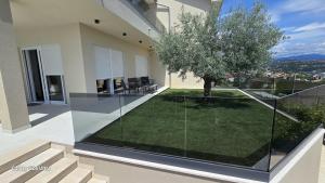 a house with a yard with a tree on the balcony at Villa Marea in Opatija
