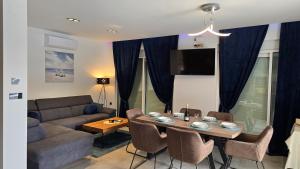 a living room with a table and a couch at Villa Marea in Opatija