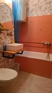 a bathroom with a sink and a toilet and a tub at Lovely apartment near NS Fair in Novi Sad