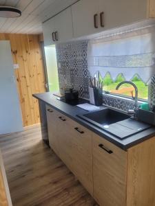 a kitchen with a sink and a counter top at domek holenderski in Mieroszyno