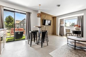 a living room with a table and chairs at The Mulberry in Logan