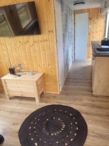 a room with a rug on a wooden floor at domek holenderski in Mieroszyno
