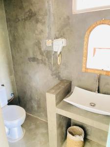 a bathroom with a toilet and a sink at Sky Breeze in Unawatuna