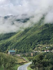 a winding road on a hill with a trainurrencyternessternessternessstrationstrationpects at Rooms DVORIŠTA in Žabljak