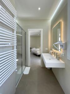 a bathroom with a sink and a mirror and a bed at Settimo Cielo al Massimo Guest House in Palermo +154 photos