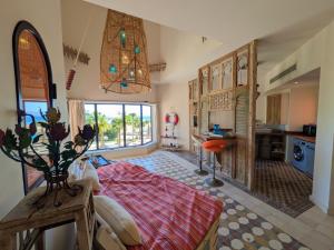 a large room with a bed and a kitchen at Super Central Somabay 2BR Marina Apt w Free Beach in Hurghada