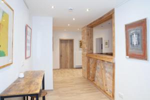 a living room with a wooden table and a wall at Dorfwirt Pfronten in Pfronten