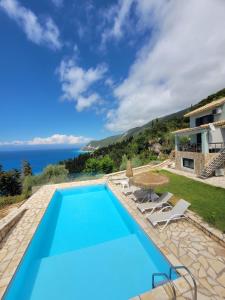 a villa with a swimming pool and the ocean at Villa ioli breathtaking view & sunset in Agios Nikitas
